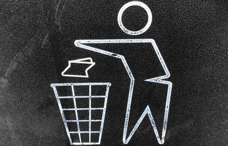 Liitutaululle piirretty ikoni roskien laittamisesta roskiin.